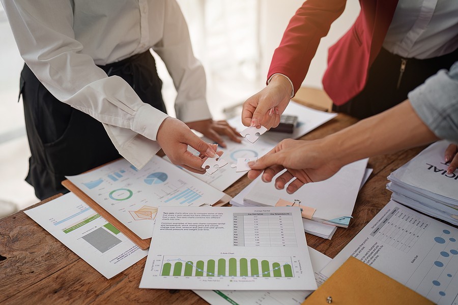 A work team looking at documents trying to streamline your business processes.