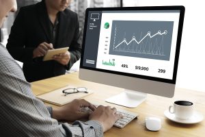 A business owner examines sales data from sales forecasting techniques.
