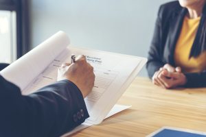 Hiring manager reviewing a recruitment rating sheet during a job interview