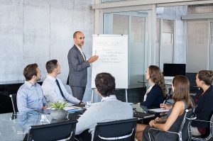 Business team in meeting discussing annual goals and strategies to prepare for slow seasons