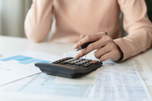 Business owner calculating taxes and reviewing financial documents